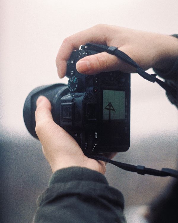 A photographer looking through a camera
